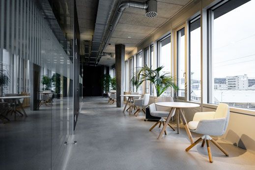 Office corridor with large windows and seating
